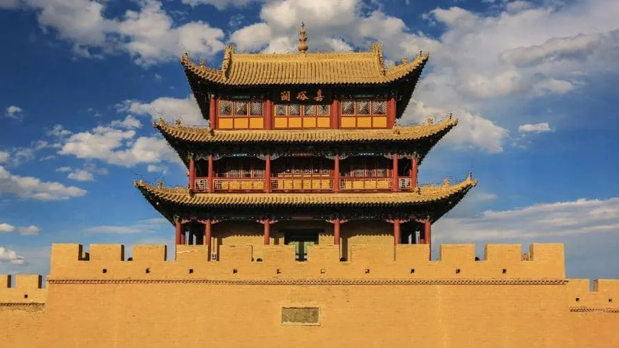 The grand three-tiered Ming Dynasty watchtower of Jiayuguan Fortress standing strong under a clear blue sky