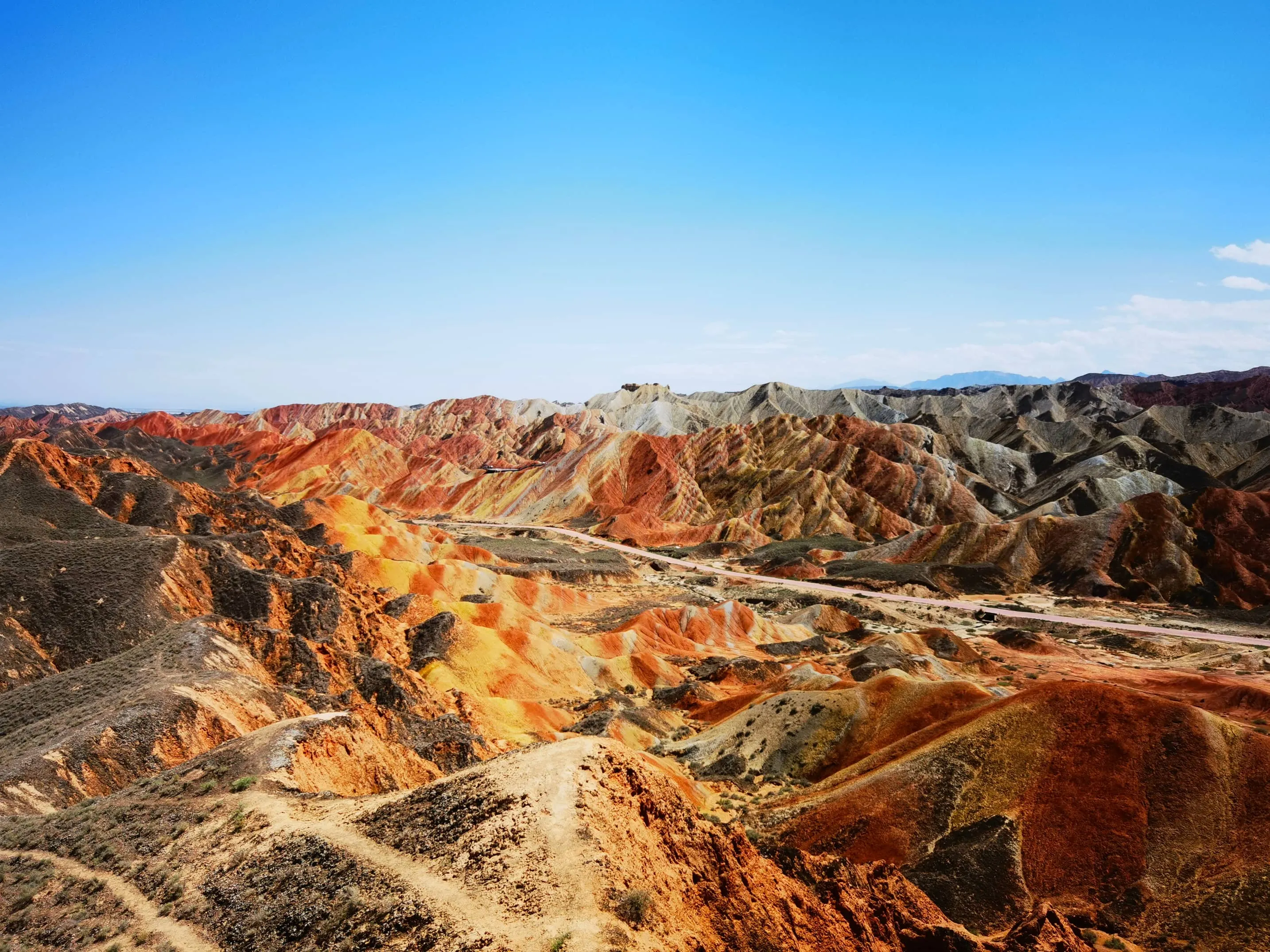 The grand panoramic view from Platform 1 showing the vast scale of the colorful ridges